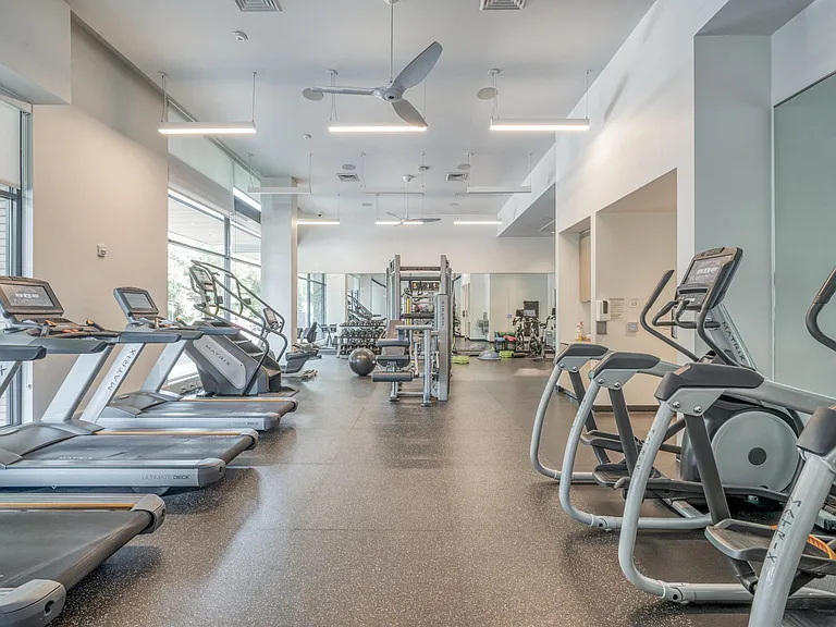 HIIT inspired fitness studio with TRX bands, weight stations and cardio equipment