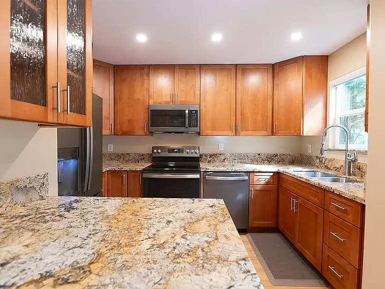 New cabinetry and appliances and plumbing granite countertops