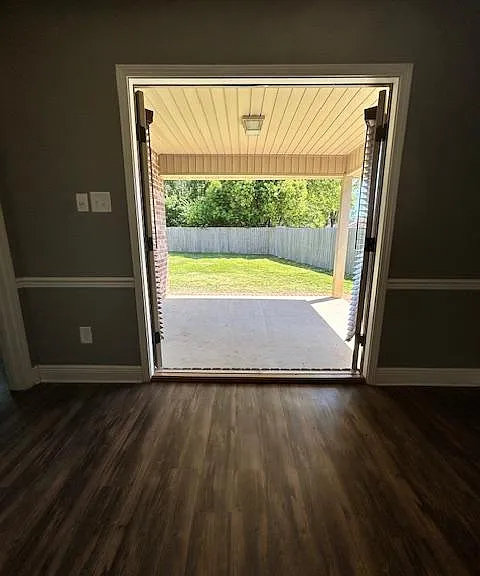 Double doors open from eating area out into the patio and backyard
