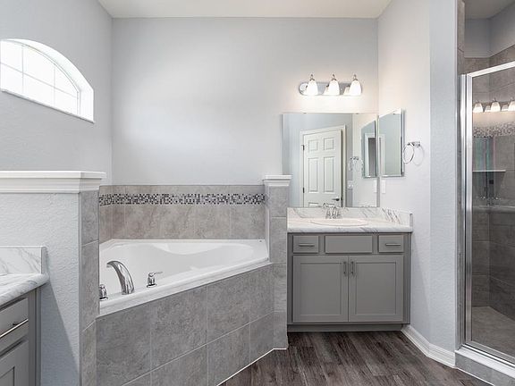 The en-suite owner s bath also includes a tiled shower and closeted toilet - New home for sale