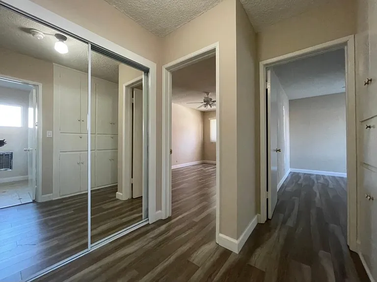 Mirrored wardrobes in hallway, storage cabinets and drawers