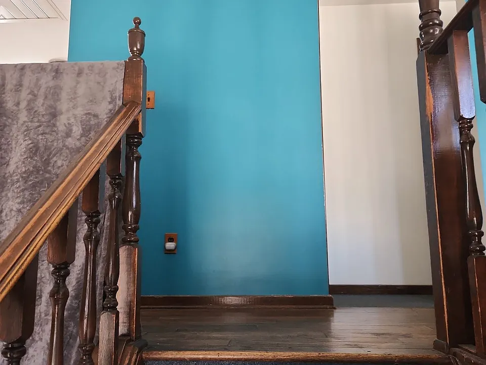 Hall way leading to kitchen and dining room to the left; three bedrooms, bathroom and living room to the right