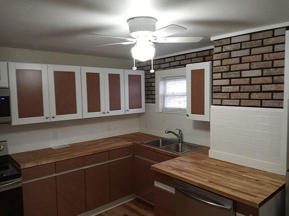 spacious kitchen with butcher block countertops and new appliances