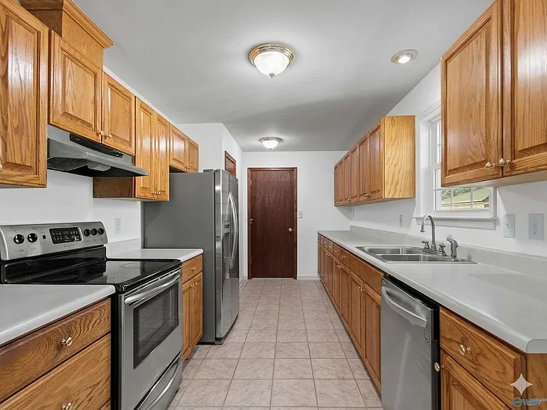 Kitchen with self cleaning oven, dishwasher, and fridge
