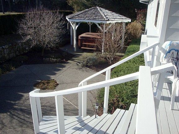 Take the Circular Stairs from your Deck to the Sunken Patio with Hot Tub and Gazebo Included
