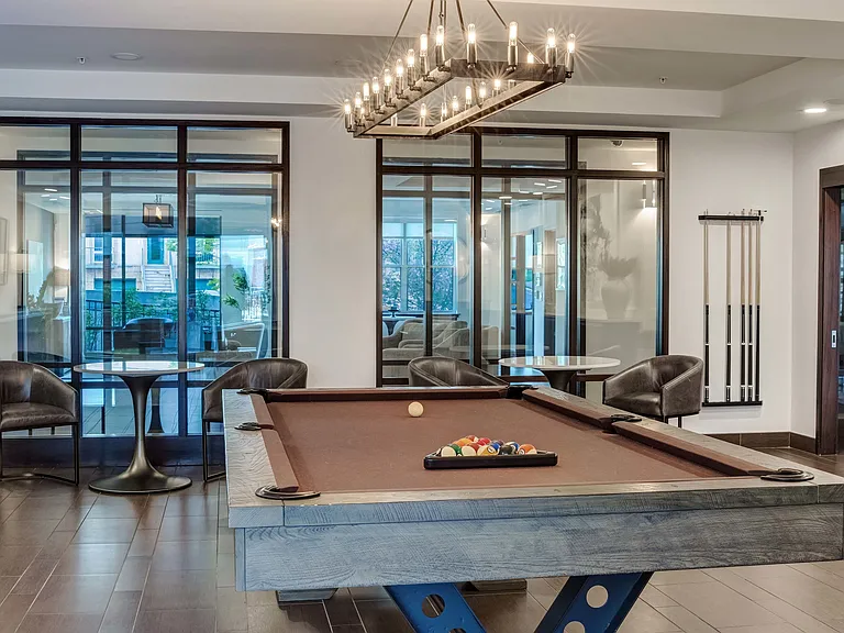 Socialize with friends enjoying a billiards game in the newly redesigned resident lounge