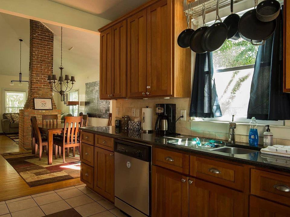 View of kitchen, dining, and living room in background.