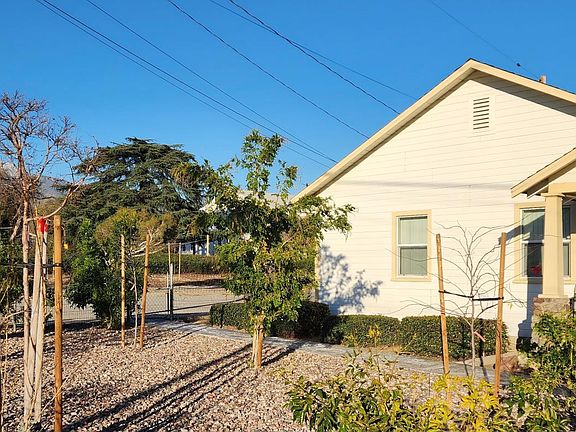 new landscaped front yard with colorful trees,shrubs,& decortive rocks