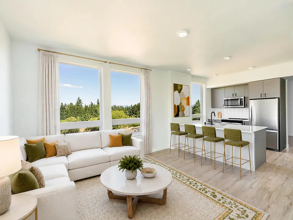 Premium homes feature oversized windows, expansive open-concept layouts, quartz kitchen islands with generous seating, and elevated views that bring natural beauty indoors.
