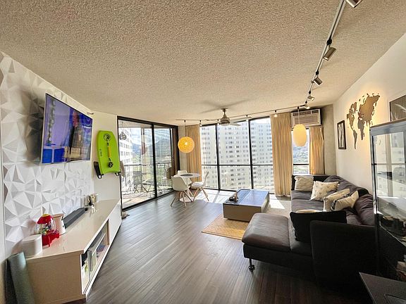 Spacious living room with a/c, ceiling fan and dimmable lighting.