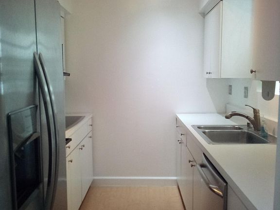 Kitchen with refrigerator, microwave and dishwasher.