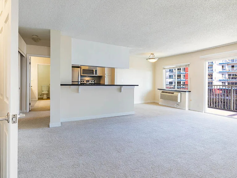 Carpeted Living Room with Balcony