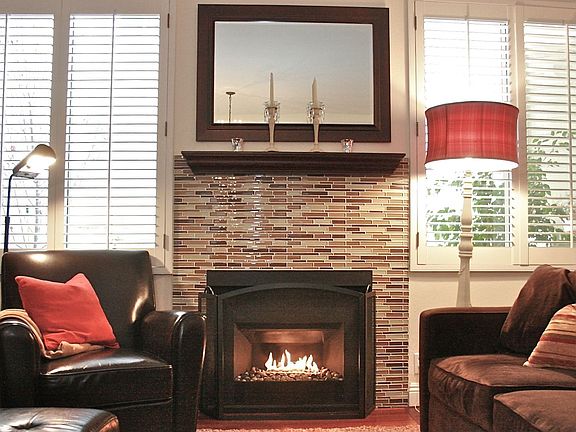 Glass tile surrounding the River Stone fireplace - a modern yet classic touch