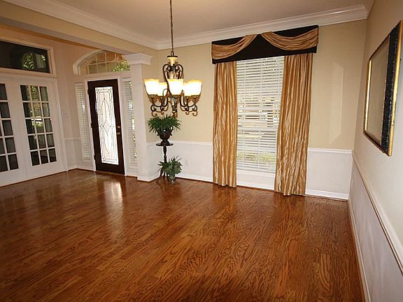 The formal dining room as seen from the entry.  Hardwoods throughout except for bedrooms.
