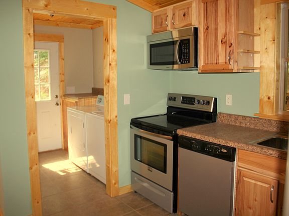 Laundry room adjacent to kitchen has washer and dryer
