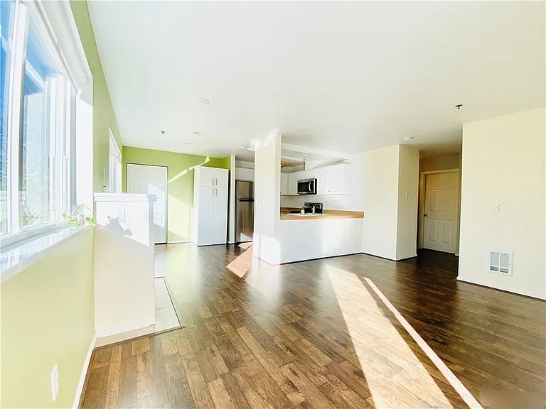 Living area showing pantry and washer/dryer/storage closet.