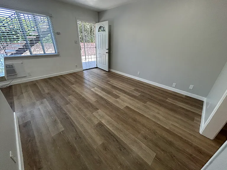 Living room facing the front door and natural light from window.