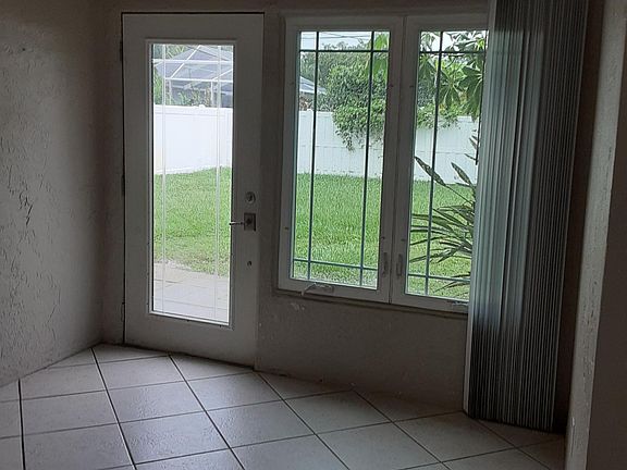 Exit from dining room to a fenced in back yard
