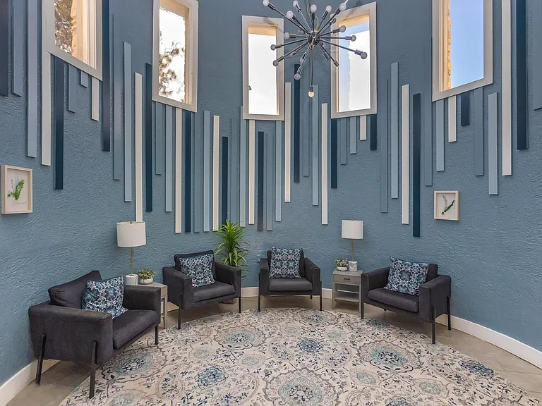 Experience the elegance of Distinction Apartment Homes, featuring a stunning lounge with modern decor and vibrant natural light. Enjoy a space designed for relaxation and connection. Explore your new home today!