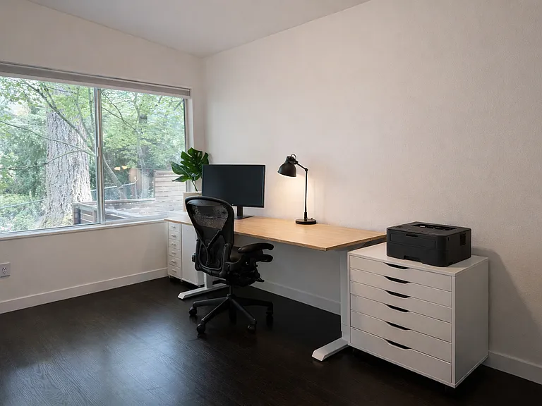 office room with stand up desk and printer.