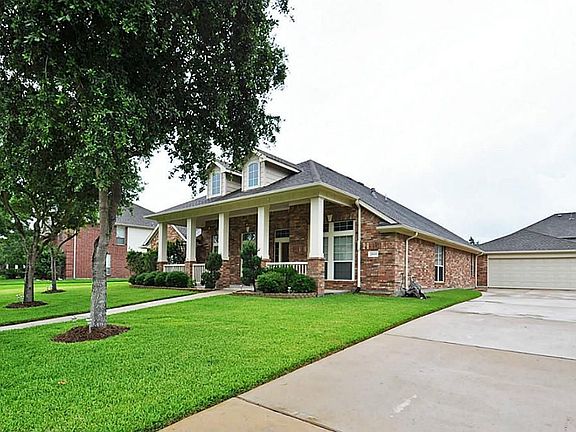 4 car tandem garage with opener, workbench area, painted floor, and addition storage above. Plenty o