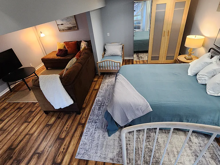 The unit is unfurnished, but these photos give an idea of how much room is available downstairs.