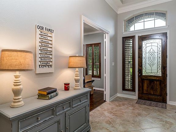 The front entry is graced by a knotty alder leaded glass door, with oversized tile set on a diagonal that flows all the way through the family room & kitchen area! A hallway to the mud/laundry room & half bath, along with 2 storage closets is tucked 