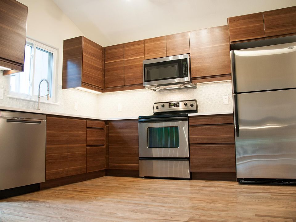 Gourmet modern kitchen with walnut cabinets, quartz countertops