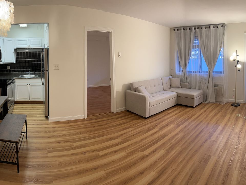 Panoramic view of living room and area of dinner with table and chairs