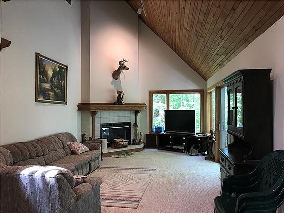 Two story living with impressive mantle and fireplace- windows and doors open to your own woods!