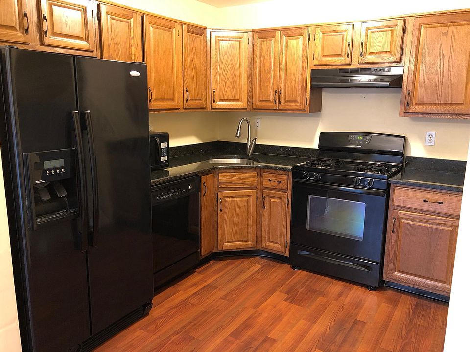 Kitchen w/ wood cabinets and Pergo style flooring