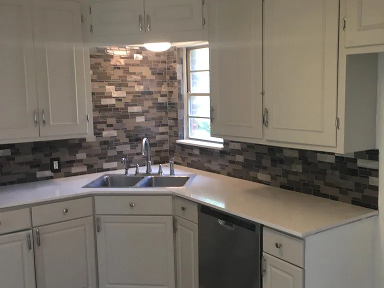 New kitchen with granite counter tops and designer backsplas