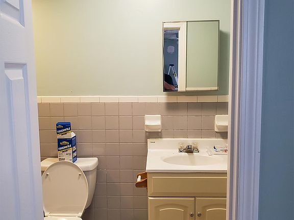 Brand new toilet, tile bleached.