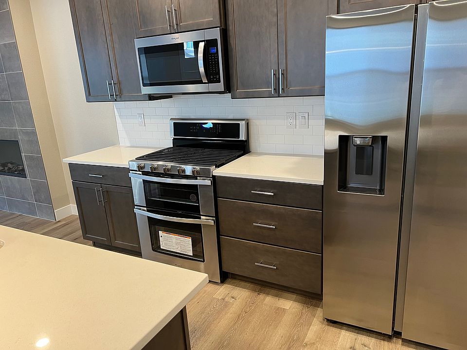 Stainless steel appliances including Gas-operated range, electrical microwave and refrigerator