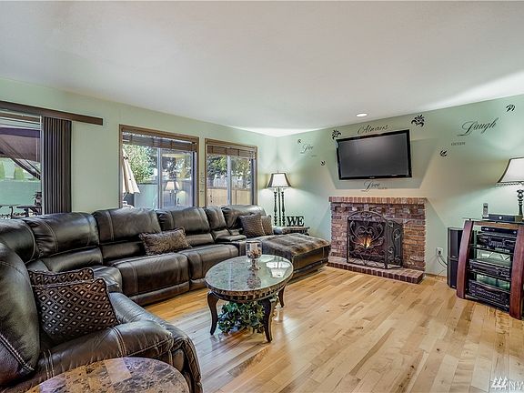 Spacious family room with wood burning fireplace and access to the new Trex style deck with enclosed gazebo.  
