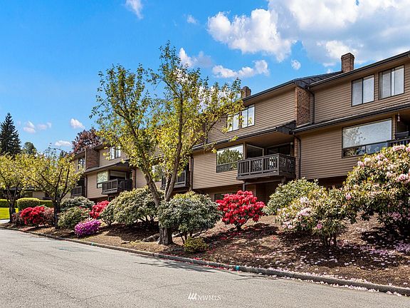 This three-story townhouse is surrounded by mature landscaping.