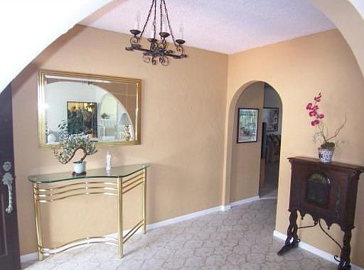 View of foyer from living room, nice arches