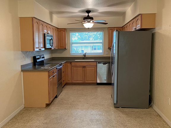Kitchen with stainless steal appliances and area for dining table.