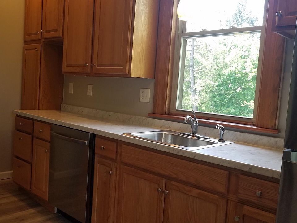 Kitchen has stainless steel appliances, including gas stove, refrigerator and dishwasher.