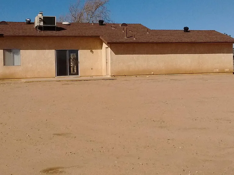Back of home with patio.