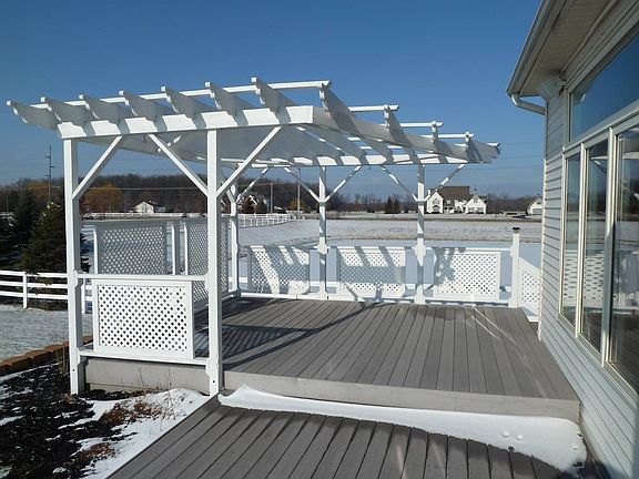 Deck with trelles overlooks lake