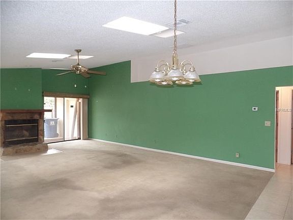Living room and fireplace with sliding doors to porch and yard
