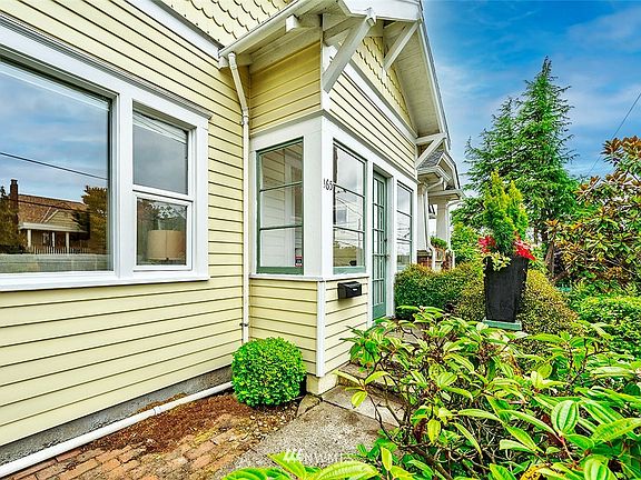 Covered porch entry, updated windows, house sits high above the street.