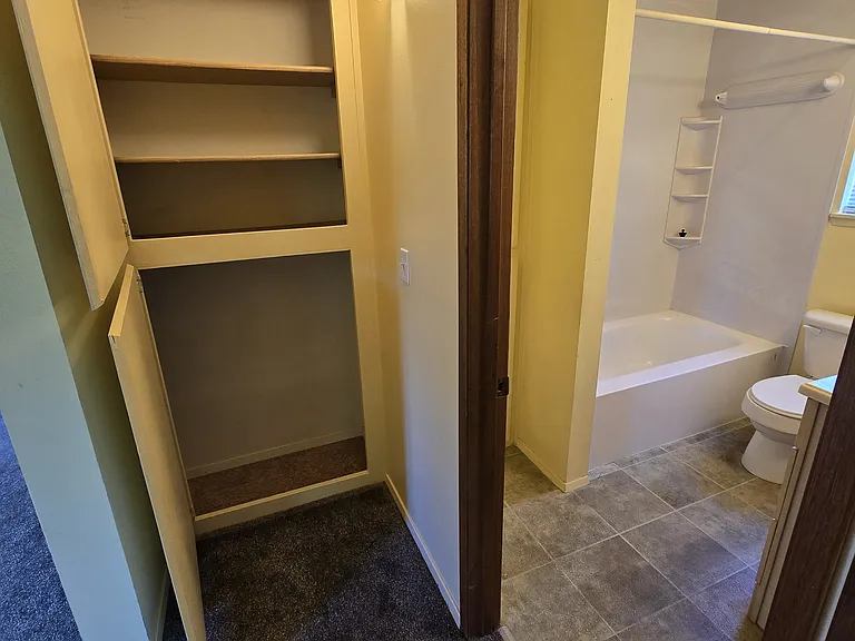 Storage closet in hallway outside of main bathroom