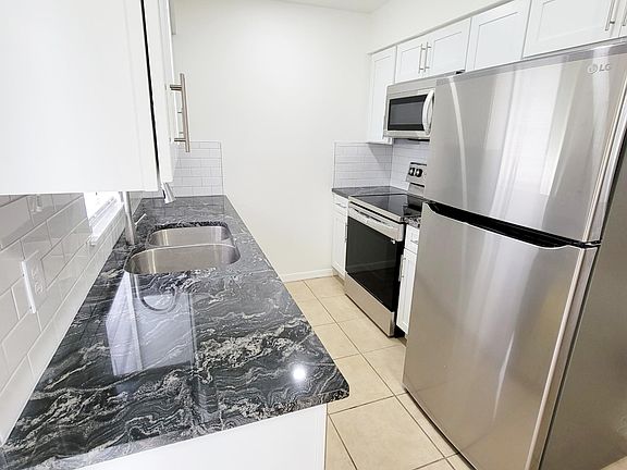 Kitchen: Galley Style Kitchen, Granite Counter Tops, New Stainless Steel Appliances. Recessed Can Lighting.