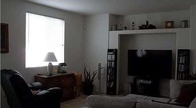 Yet another view of your lovely family room with window looking into the pretty back yard.