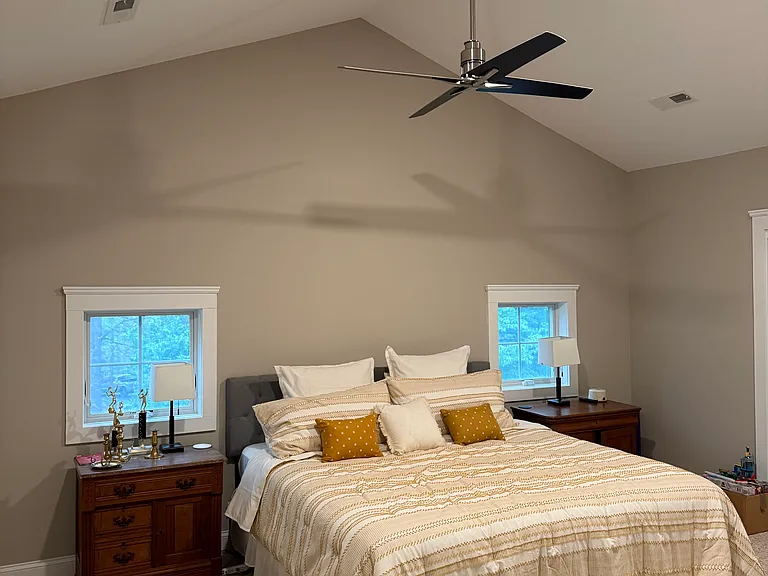 King sized bed with daybed and trundle and night tables ceiling fan massive storage