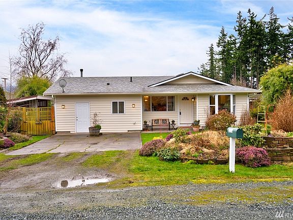 Front yard view of this cute rambler.  The yard is a certified Wildlife Sanctuary!  Lots of beautiful plantings that provide gorgeous color year round. 