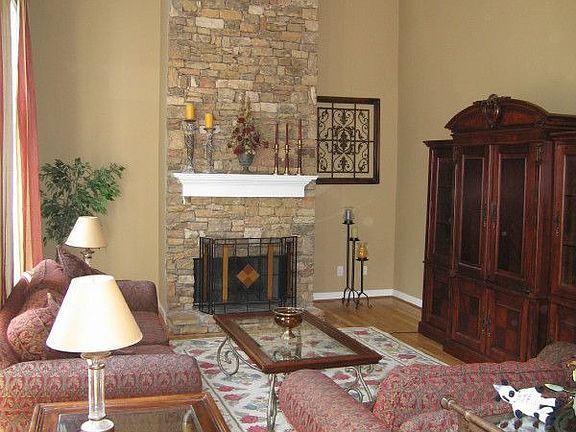 2 story great room with stacked stone fireplace and wall of windows