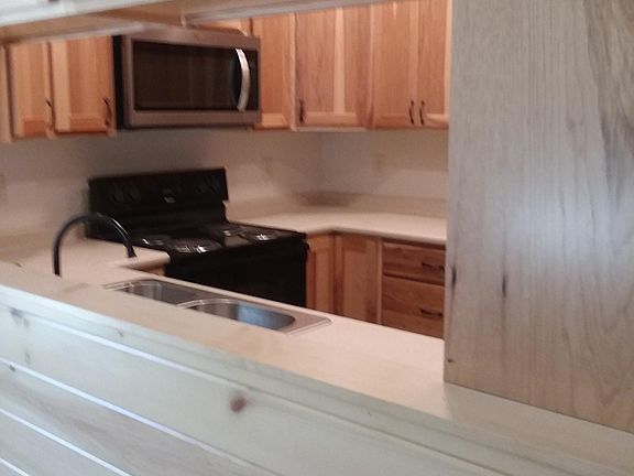 Hickory Cabinets, Stainless steel appliances, sink bar that separates dining room from kitchen, plenty of storage space, and dishwasher